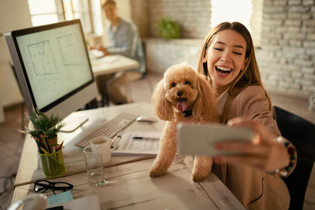 A woman taking a selfie with a dog