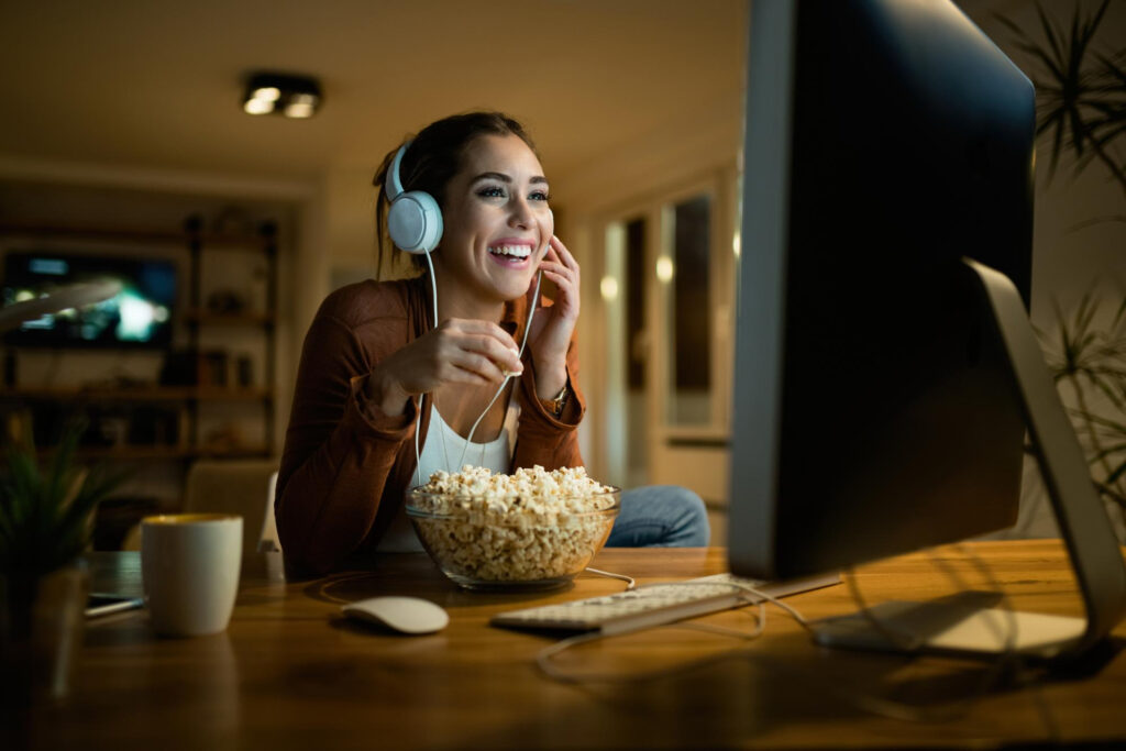 a girl eating popcorn and enjoying the high speed internet