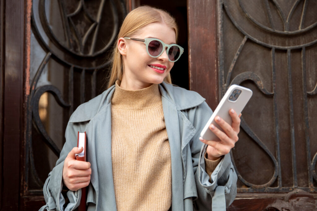 woman with Meta smart glasses is watching at her phone