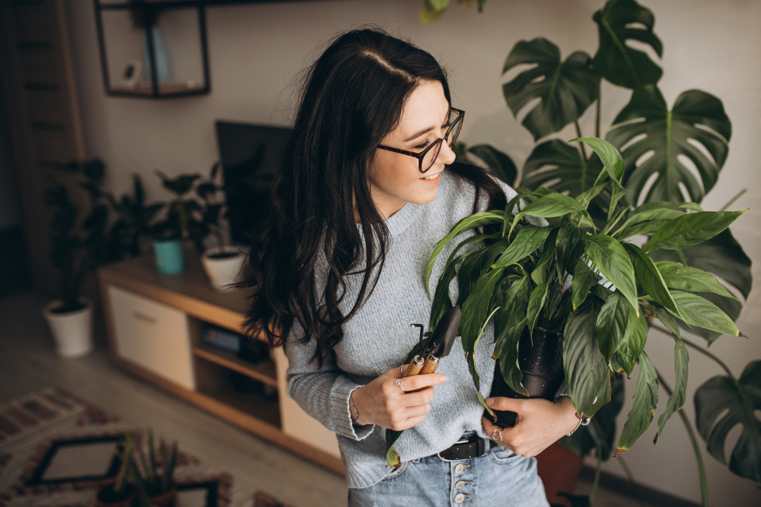 woman incorporating indoor plants to her home