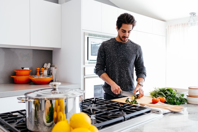 a man cooking with a pressure cooker