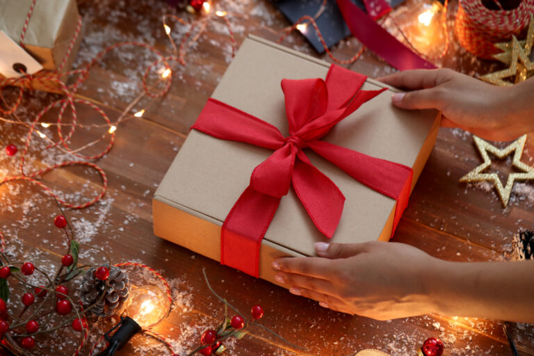 person wrappung christmas gift for their partner
