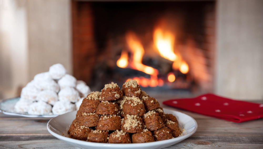 greek dessert traditional homemade melomakarono and kourabies on a wooden table