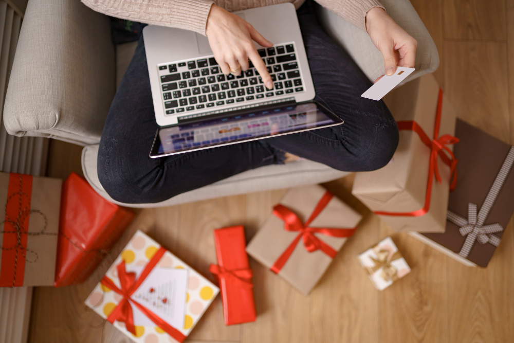 image of pleased nice woman holding credit card with copy space using laptop