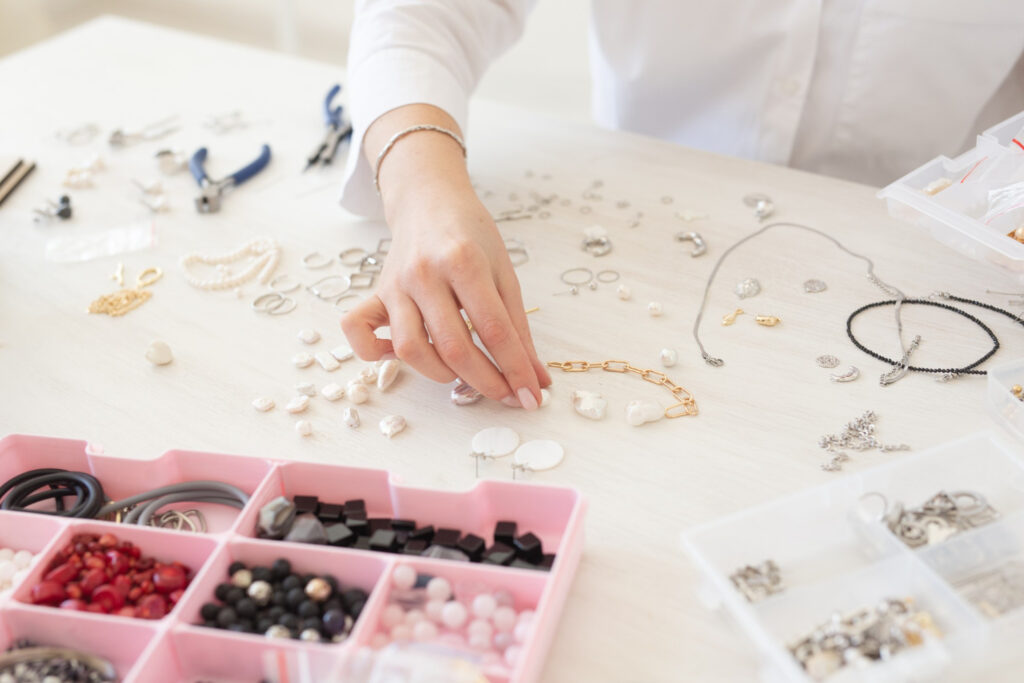 jewelry designer making handmade jewelry in studio workshop closeup