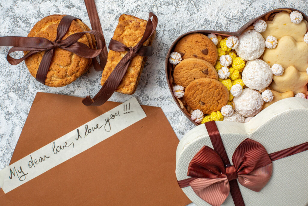 top view tasty sweets biscuits cookies and candies inside heart shaped box on white surface sugar