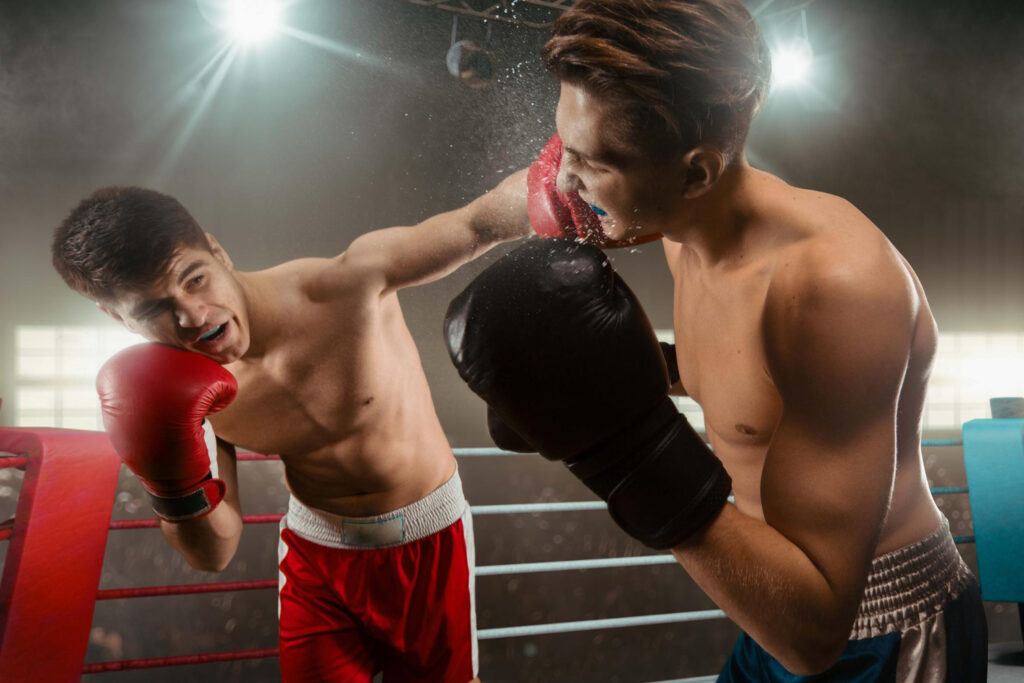  two boxers are fighting on professional boxing ring