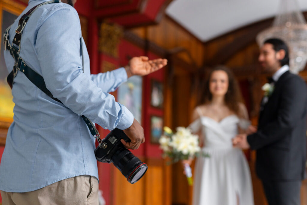 A photographer talking to the wedding couple