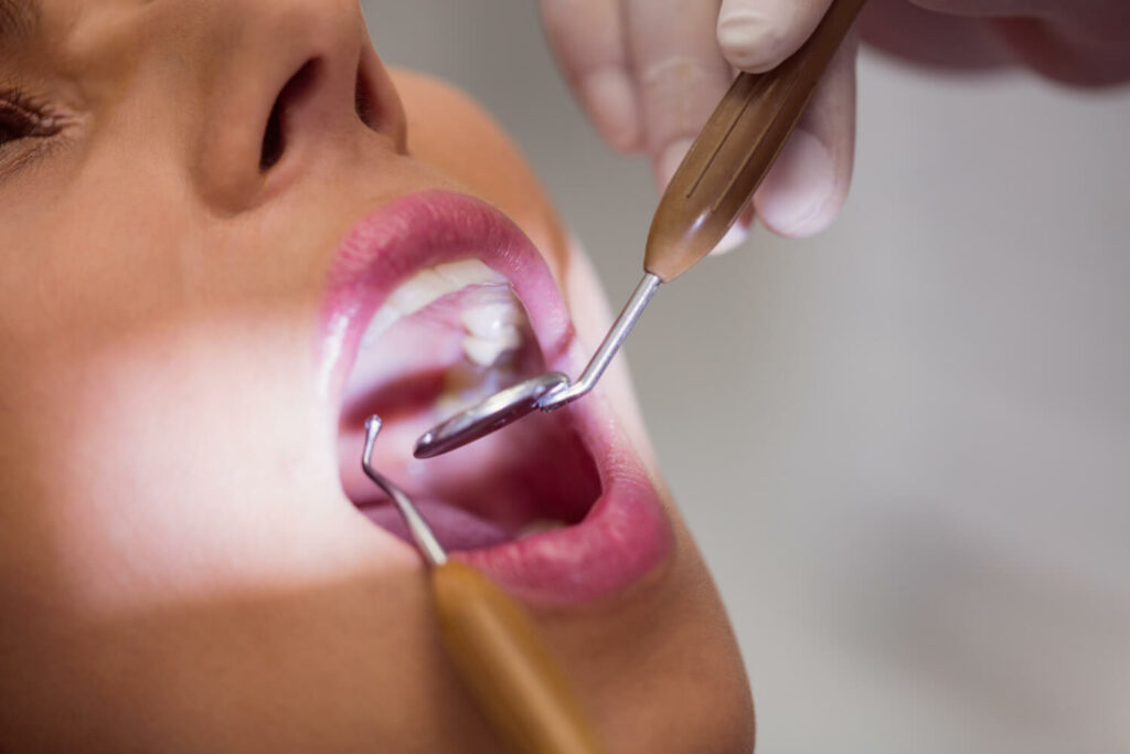 a dentist looking at woman's teeth