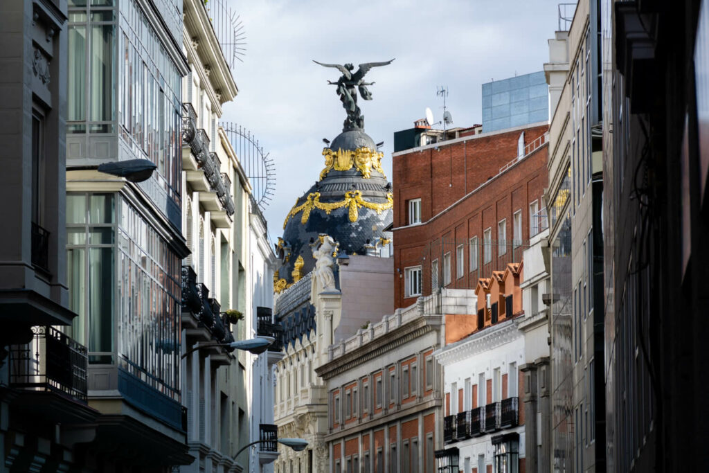 Closeup shot of a dome with Victoria statue, Metropolis Building, Madrid