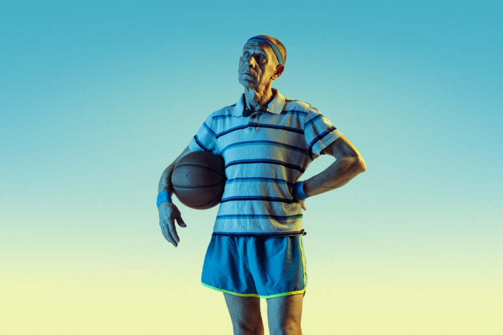 an older guy wearing a basketball headband and holding a basketball ball