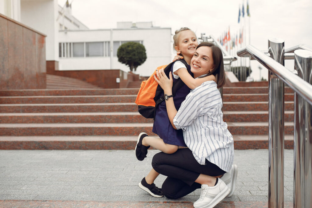 mother and child in front of school