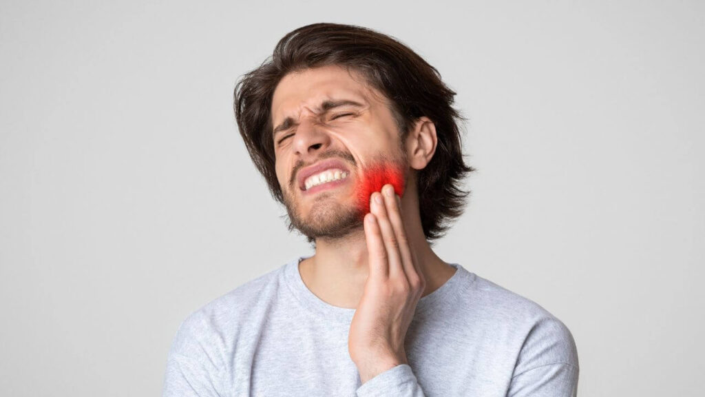 a guy in pain from a toothache